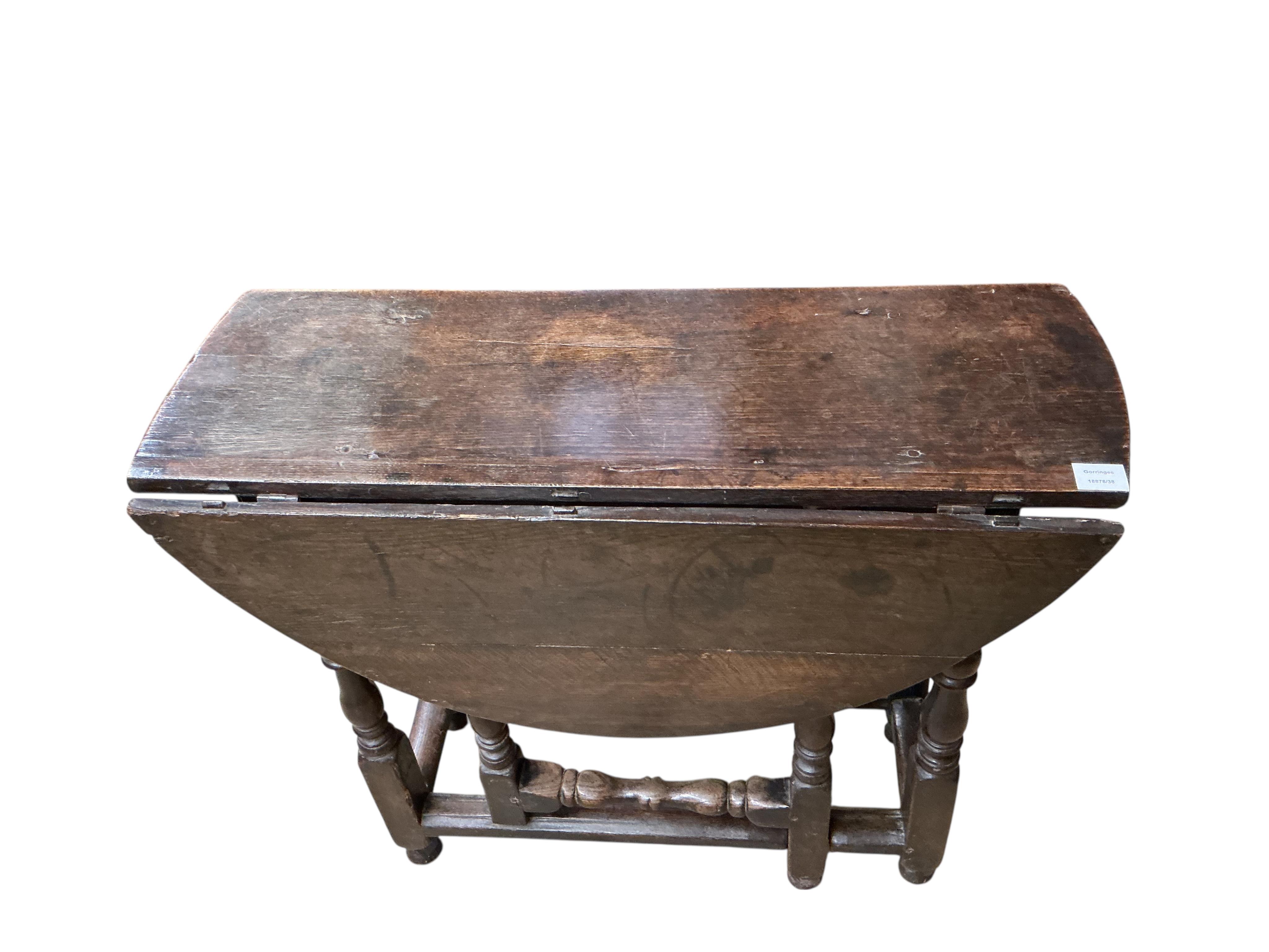 A small 18th century oval oak gate-legged table, width 92cm, depth 36cm, height 75cm